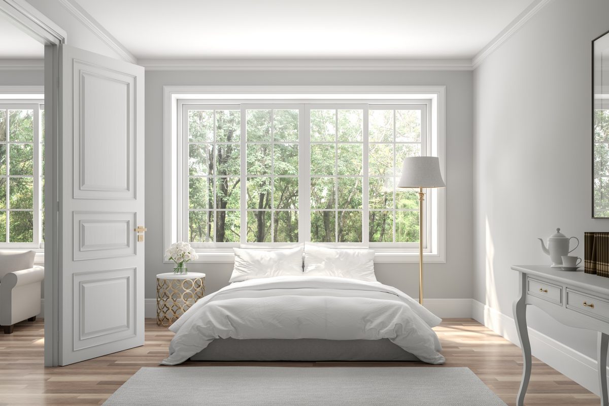 Classical bedroom and living room 3d render,The rooms have wooden floors and gray walls ,decorate with white and gold furniture,There are large window looking out to the nature view.